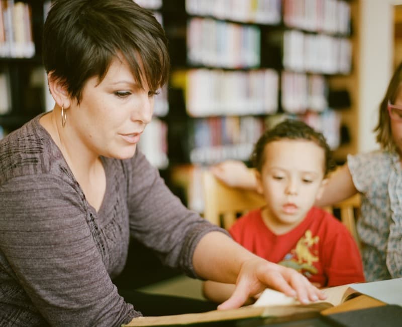 A teacher reading with a student